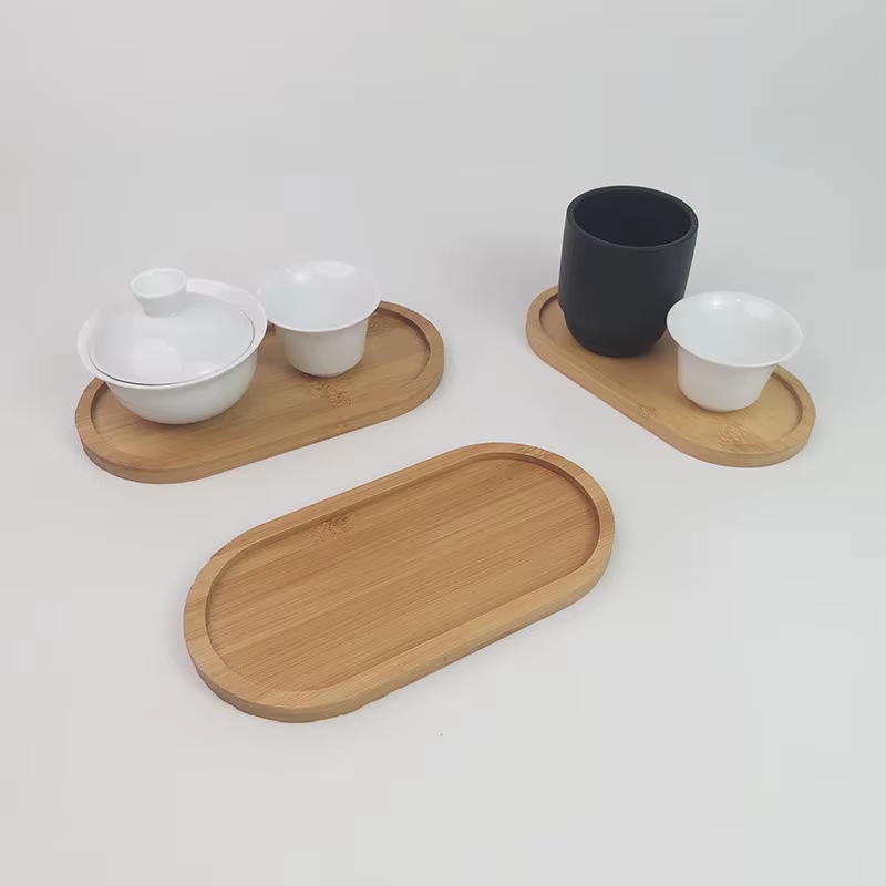 Ridgeline bamboo oval trays holding a white tea set and a dark ceramic mug