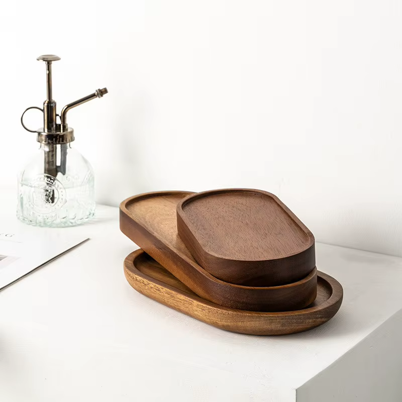 Ridgeline oval and rectangular wood trays nested in a stack on a countertop